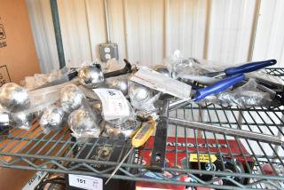 Lot of various utensils including spoodles, scoopers, and ladles, mostly in packaging, with visible auction tags.