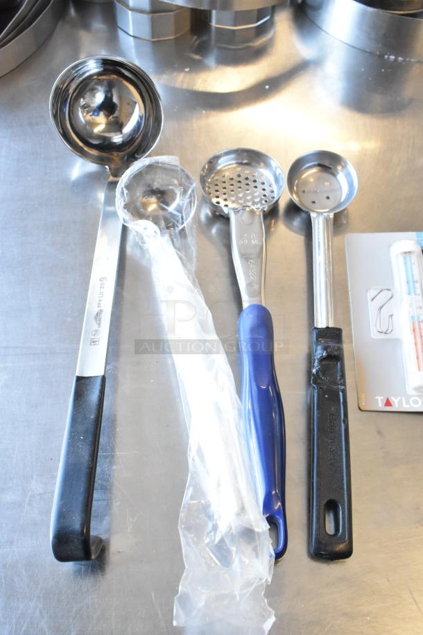 Lot of various utensils including spoodles, scoopers, and ladles on a metal surface. One has a visible 6 oz marking.