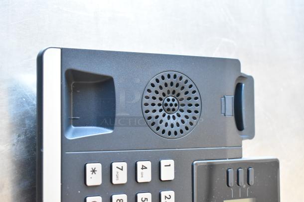 Verizon corded telephone with keypad and speaker, part of a four-item auction lot.