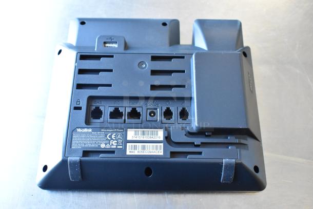 Alt text: Yealink IP phone base, showing ports and label with model number SIP-T48S, certification marks, and MAC address.