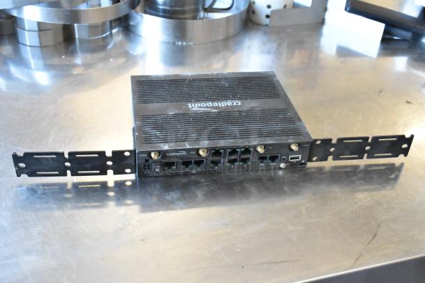 Cradlepoint AER2200 router, has multiple ports, black finish, mounted on a metallic surface.