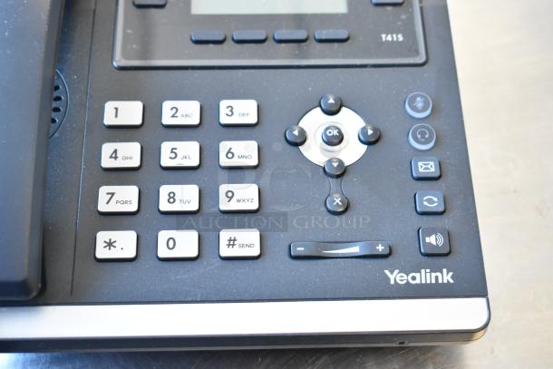 Yealink T41S corded phone close-up, showing keypad and control buttons.