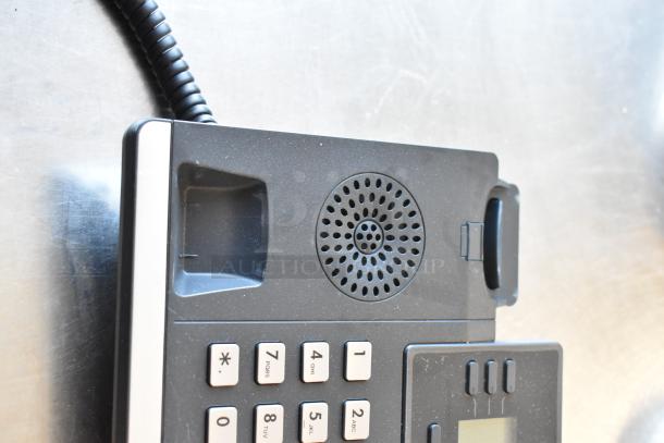 Verizon corded telephone with numeric keypad and speaker, in used condition. Part of a four-item auction lot.