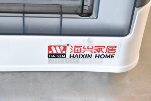 Haixin Home poly bin with clear cover, part of a lot including three bins and contents. Marked with Haixin Home logo.