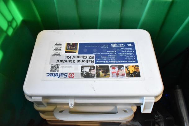 Lot of various items including three poly bins. Visible item: Safe Tec National Standard EZ-Cleans Kit with labeled contents.