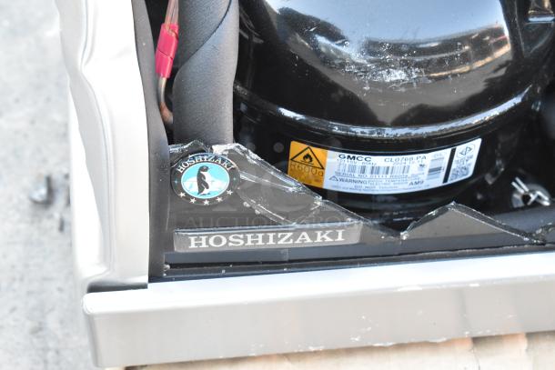 Hoshizaki HNC-210BA-L-SLH sushi display merchandiser with broken glass, 115V, logo badge visible, black and metal exterior.