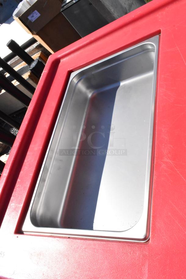 Cambro red poly portable work station with stainless steel insert. Features commercial casters. Good condition.