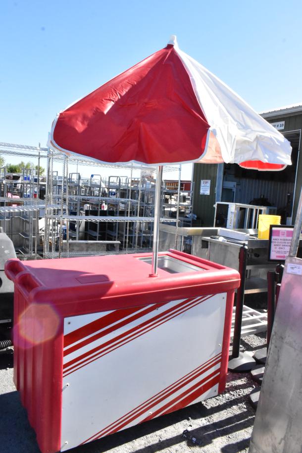 Cambro red poly portable work station with umbrella, on commercial casters. Features red and white design. Good condition.