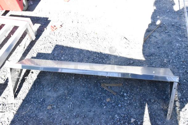 Two wall mount metal shelves, each 48x12x12 inches, shown on rough ground. Silver finish, slight wear.