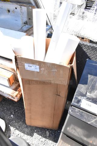 Box of white material rolls, standing upright. Cardboard box shows a label marked "159" and "QTY 1".