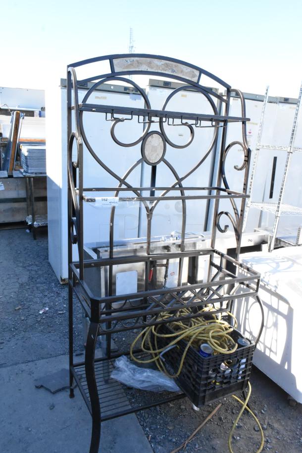 Metal frame with decorative design, containing a plastic crate with yellow rope and miscellaneous items. Used condition.