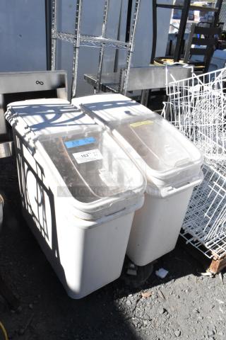 Two white poly ingredient bins on commercial casters with clear lids, labeled "A.P. flour," in used condition.