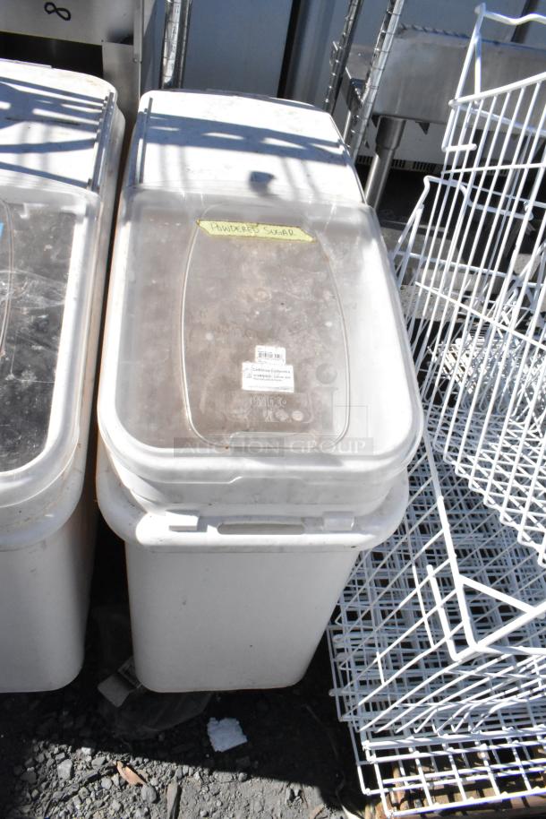 Two white poly ingredient bins on commercial casters, labeled for powdered sugar, with clear lids and label indicators.