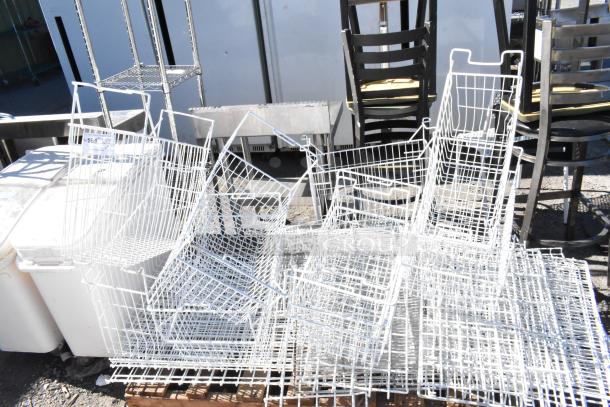 Pallet lot of white poly freezer baskets and various items. Includes metal shelves and stackable chairs. Used condition.
