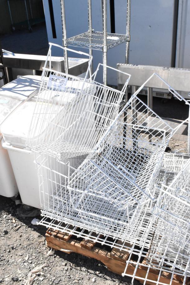 Pallet lot featuring white poly freezer baskets, various items stacked; visible tag showing “164 Poly Qty”.