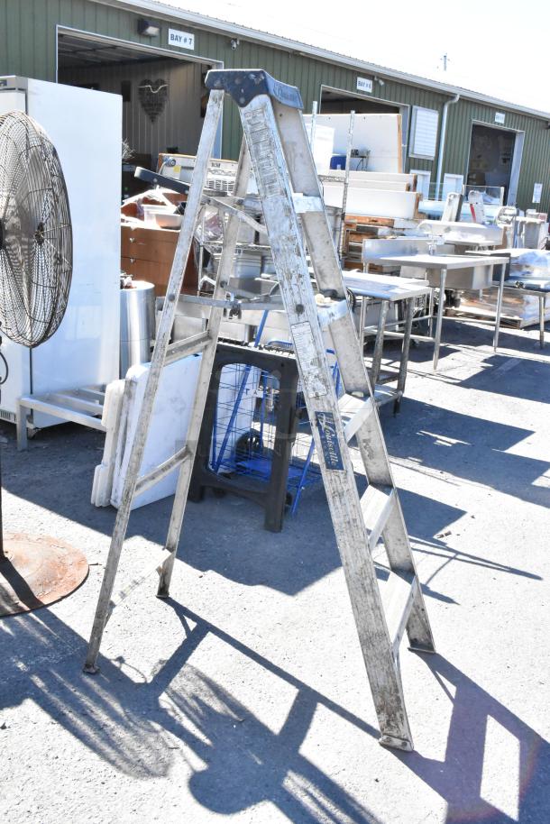 6' Louisville A-frame ladder, used condition, visible model label, durable aluminum, suitable for various tasks.