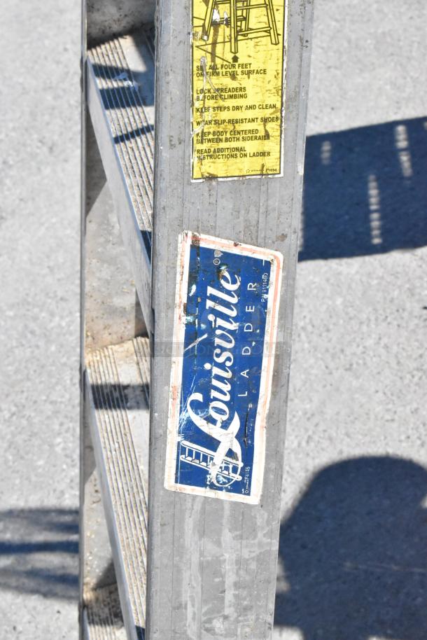 6' Louisville A Frame Ladder, metal construction, visible logo and safety instructions, used condition.