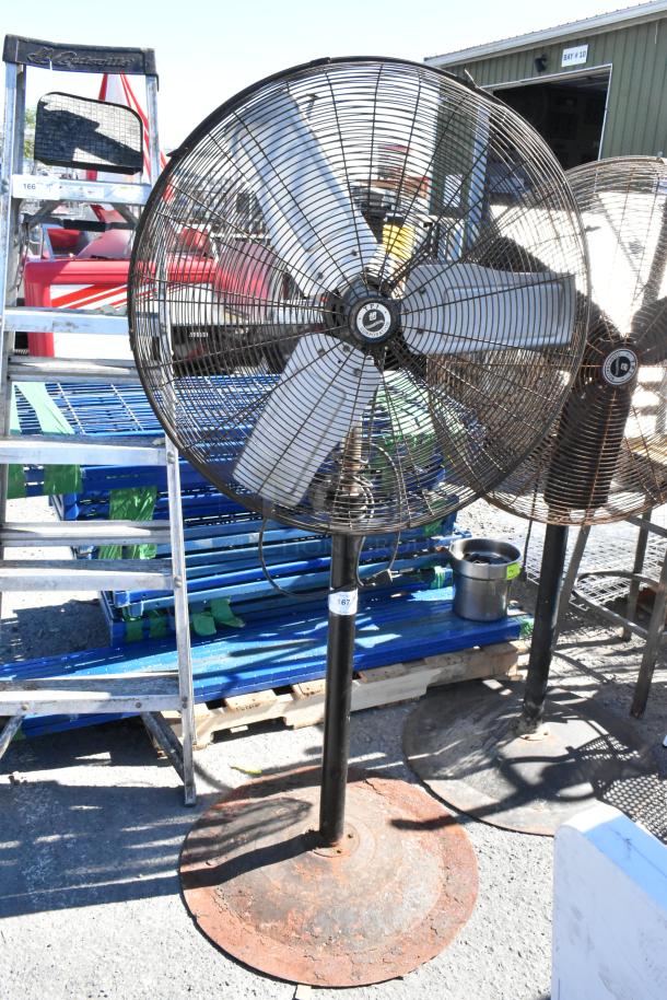 2 TPI FE-75S1fOL floor metal fans, 115 volts, 1 phase, in used condition, with sturdy bases.