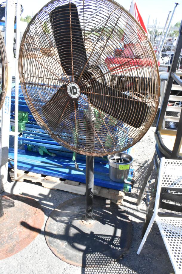 2 TPI FE-75S1fOL floor metal fans, 115 volts, 1 phase, showing wear. Robust industrial design, suitable for large areas.