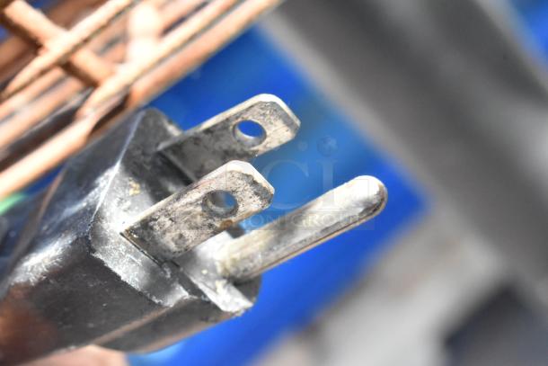 2 TPI FE-75S1fOL floor style metal fans, 115V, 1 phase. Close-up of power plug showing wear, ideal for industrial use.