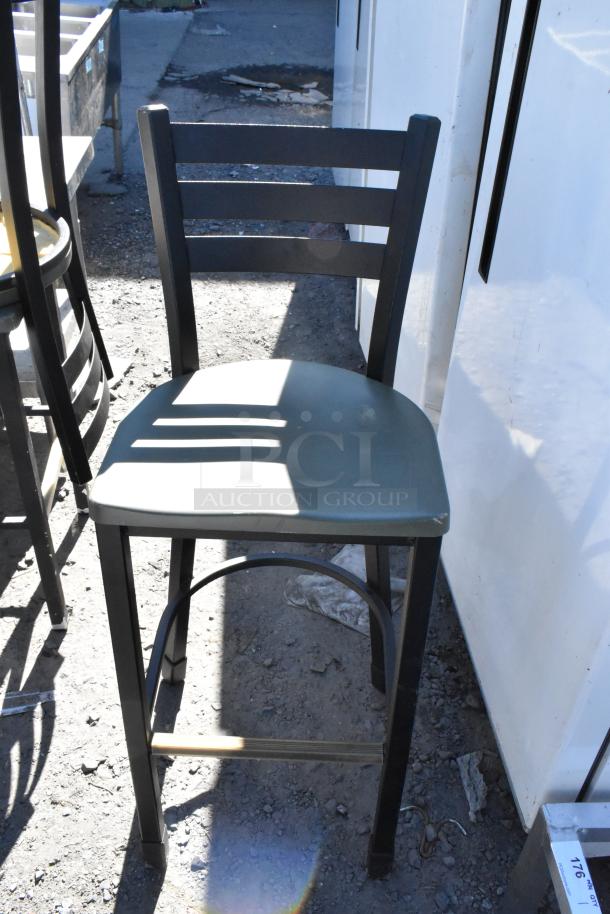 Black metal bar height chair with a green seat, part of a set of 5 varied chairs, in used condition.