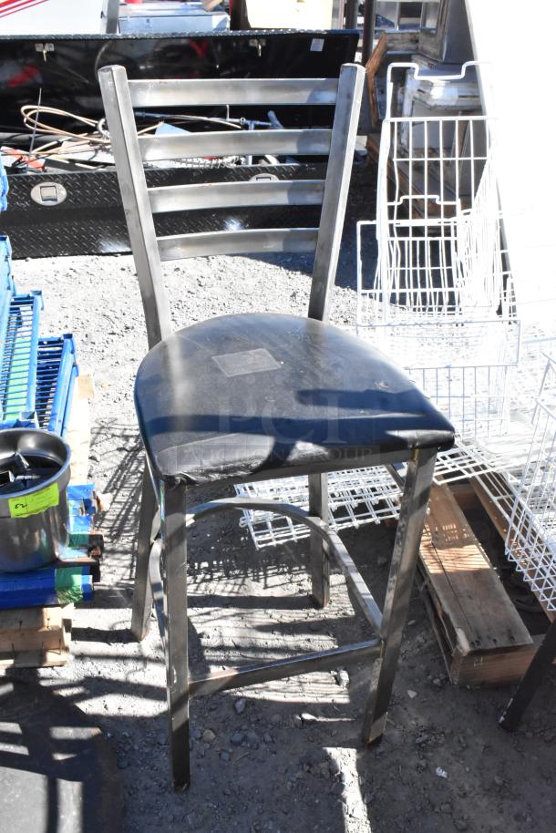 Black metal bar-height chair with a padded seat. Slightly worn condition. Ladder back design, part of a set of five.
