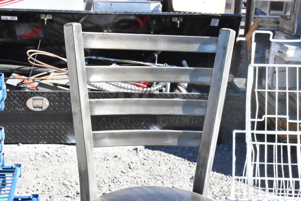 Black metal bar-height chair with ladder back design, part of a lot of five varied chairs. Used condition, minimal wear.
