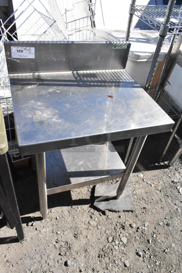 Stainless steel table with under shelf and backsplash, lightly worn, visible price tag indicates $169 each.