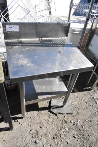 Stainless steel table with under shelf and backsplash, lightly worn, visible price tag indicates $169 each.