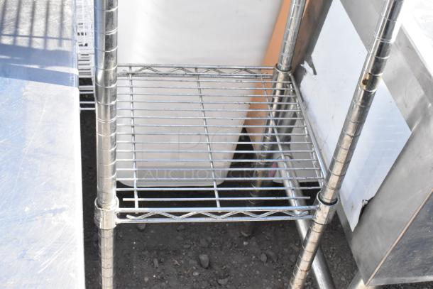 Chrome finish 3-tier wire shelving unit, sturdy metal construction, visible wear, requires dismantling for shipping.