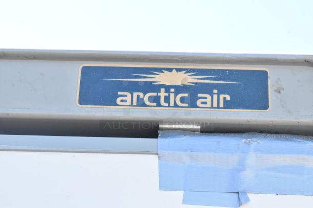 Arctic Air AWR25 metal single door reach-in cooler with logo, 115 volts, 1 phase, blue tape on surface.