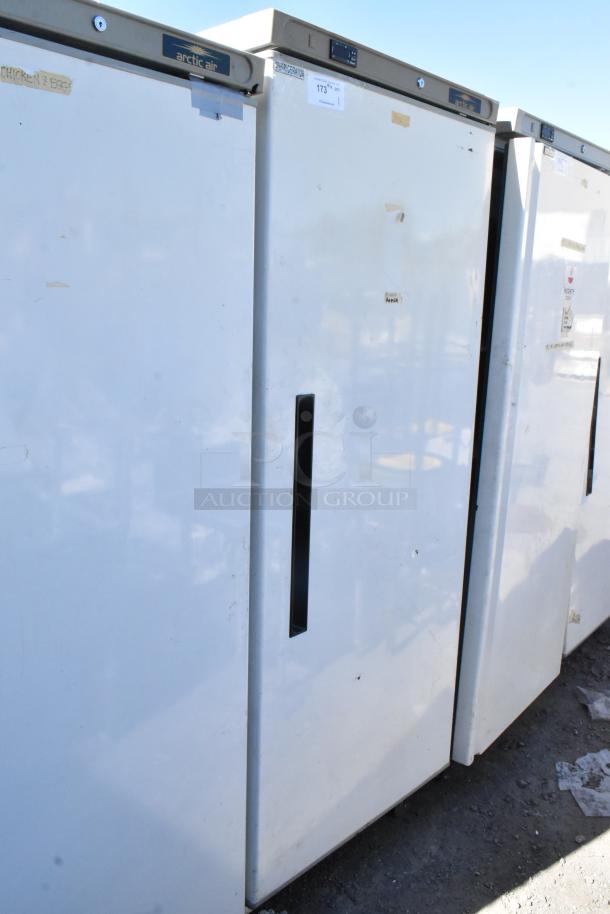 Arctic Air AWR25 metal single door reach-in cooler, 115 volts, 1 phase, visible signs of wear, taped handles, model label on top.