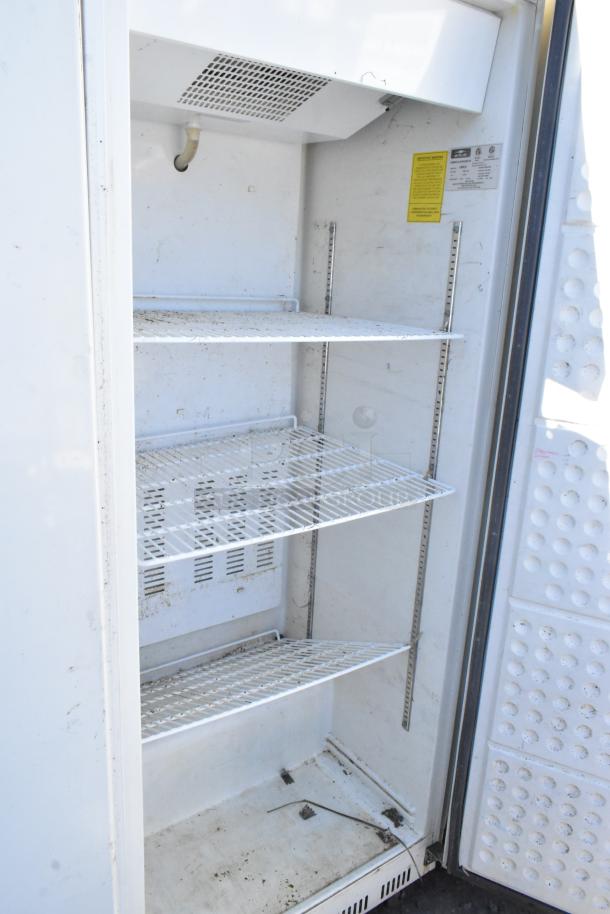 Arctic Air AWR25 metal single door cooler with adjustable shelves, signs of wear. 115V, 1 phase. Manufacturer label visible.