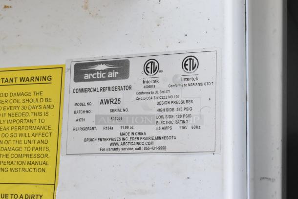 Arctic Air AWR25 single door cooler label shows model details, serial number 601004, uses R134a refrigerant, 115 volts, 1 phase.