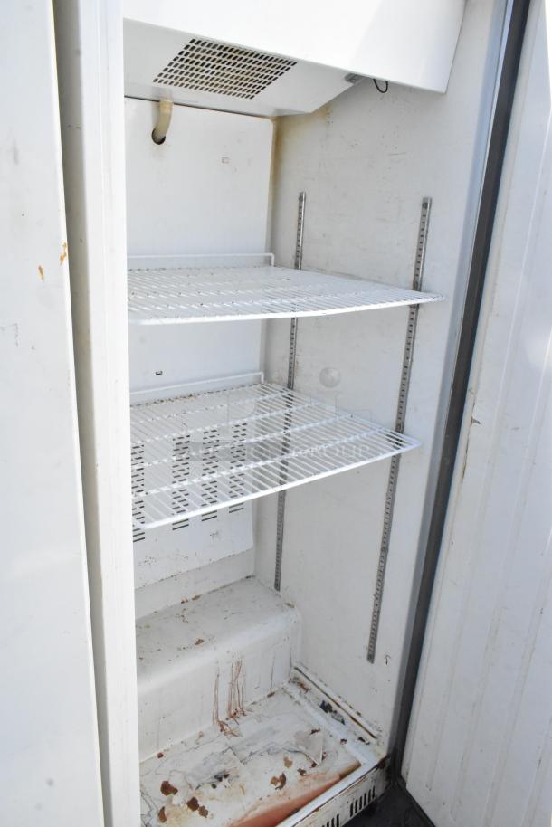Entree CR1-EC Metal Single Door Reach In Cooler, 115V, showing interior shelves, visible wear and residue on surfaces.