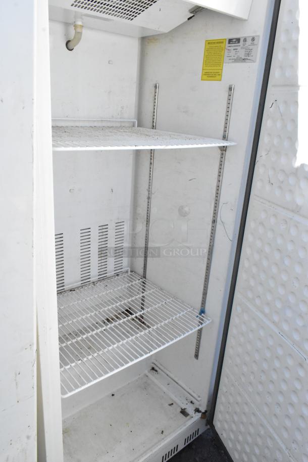 Arctic Air AWR25 metal single door cooler, used condition, 115V, 1 phase, interior wire shelves, visible wear inside.