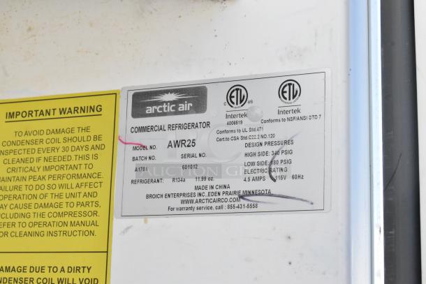 Arctic Air AWR25 metal single door reach-in cooler, 115 volts, 1 phase, with model label showing specifications and warnings.