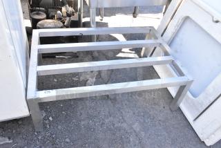 Metal Dunnage Rack with four slats, sturdy metal construction. Tag marked "176." Used for storage and easy access.