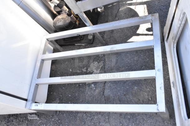 Metal Dunnage Rack in used condition, sturdy steel construction, four-bar design, ideal for storage and stabilization.