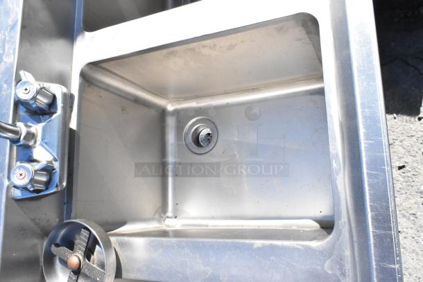 Stainless steel 3-bay sink with glass washer, featuring dual faucet controls, in used condition.