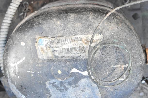 Tecumseh compressor with visible wear. Label reads "RKA9455EXD," indicating model. Suitable for repair or parts.