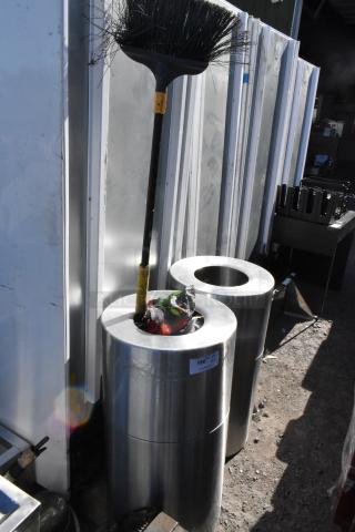 Two metal trash can shells, cylindrical shape, silver finish, good condition. Label indicates bid item, sticker shows "180 KT."