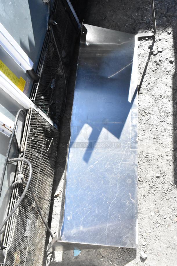 Silver metal wall mount shelf with a smooth surface, visible wear and scratches, suitable for organizing tools or supplies.