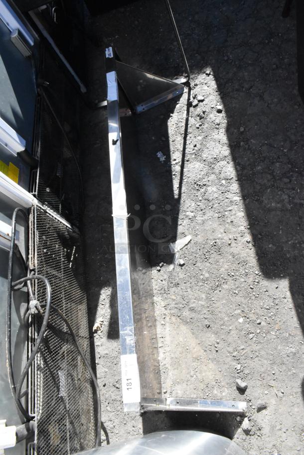 Metal wall mount shelf, features sturdy construction and metallic finish. Visible label with number 181. Good condition.