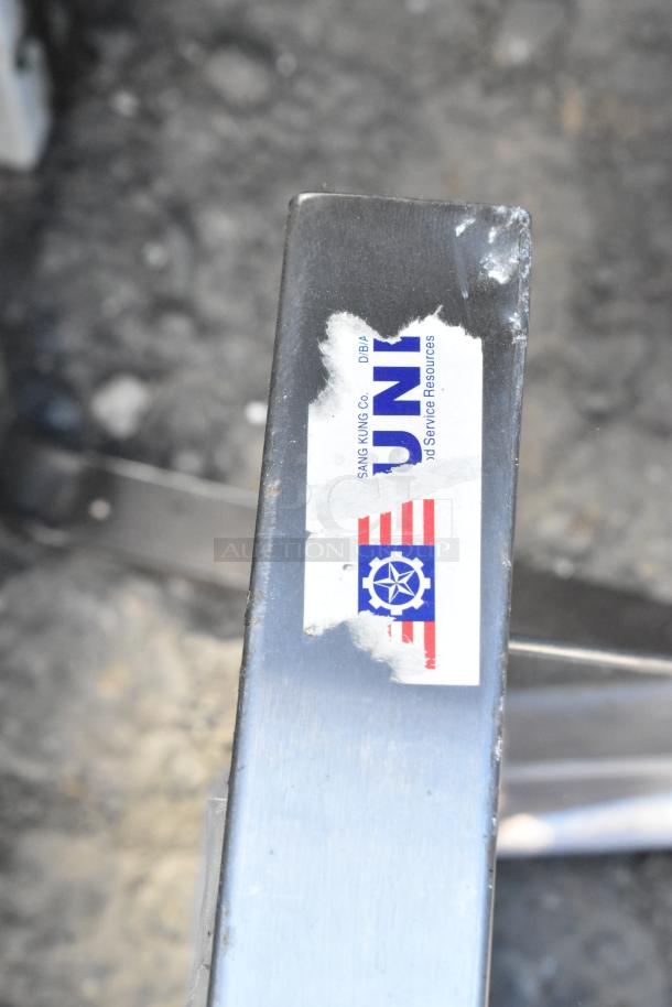 Metal wall mount shelf with visible label from Sang Kung Co., slight wear shown.