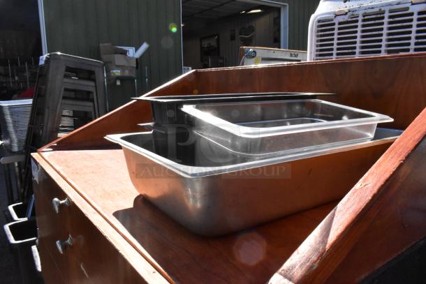 Wood pattern stand with two drawers, featuring visible metal handles. Top surface holds storage containers. Good condition.