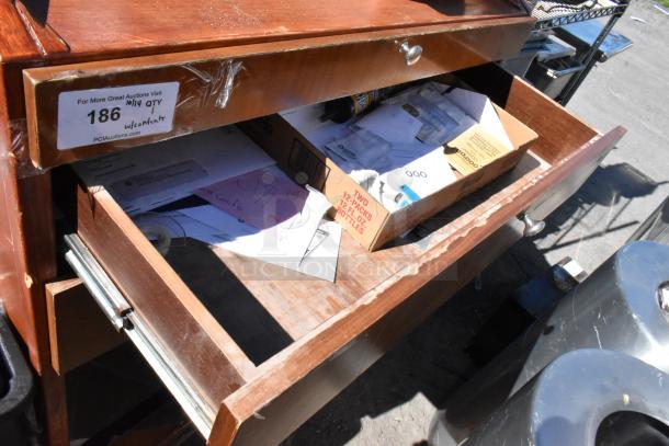Wood pattern stand with two drawers, one open showing contents. Label marked "186 w/contents." Signs of wear visible.