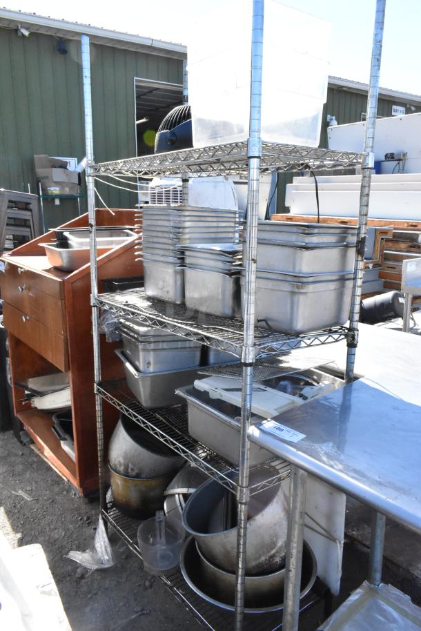 Chrome finish 4-tier wire shelving unit with stainless steel drop-in bins. Includes contents. Buyer must dismantle.