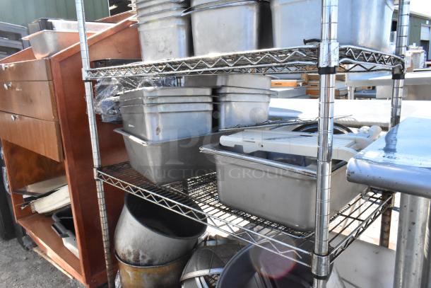 Chrome finish 4-tier wire shelving unit with stainless steel drop-in bins, used condition. Buyer must dismantle for shipping.
