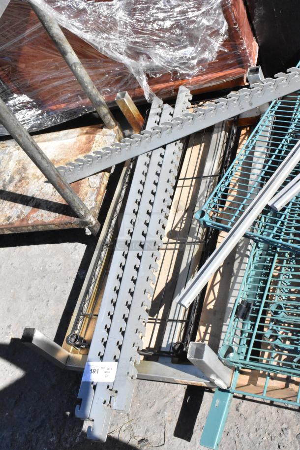 Pallet of assorted items including metal dunnage rack and green wire shelves in used condition. Label reads "Lot 191".